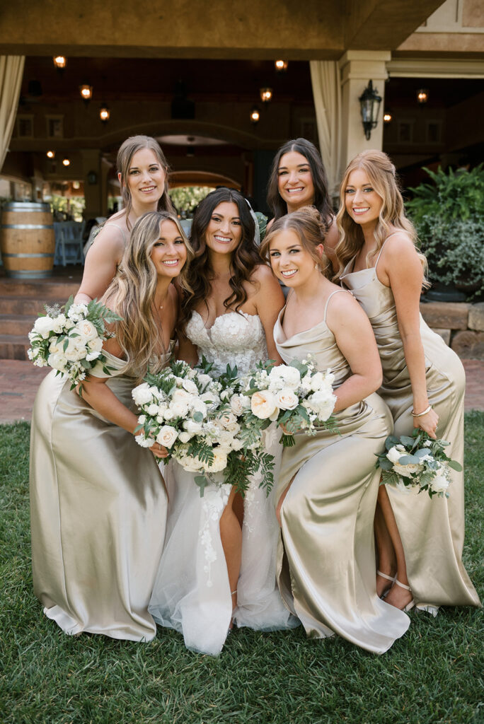Green satin bridal party standing with bride at vineyard wedding in Ohio | J. Lynne Photography