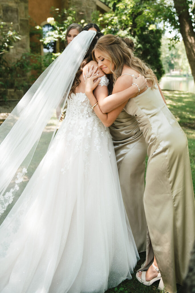 Bride hugs her bridal party at her vineyard wedding before saying "I do" | J. Lynne Photography