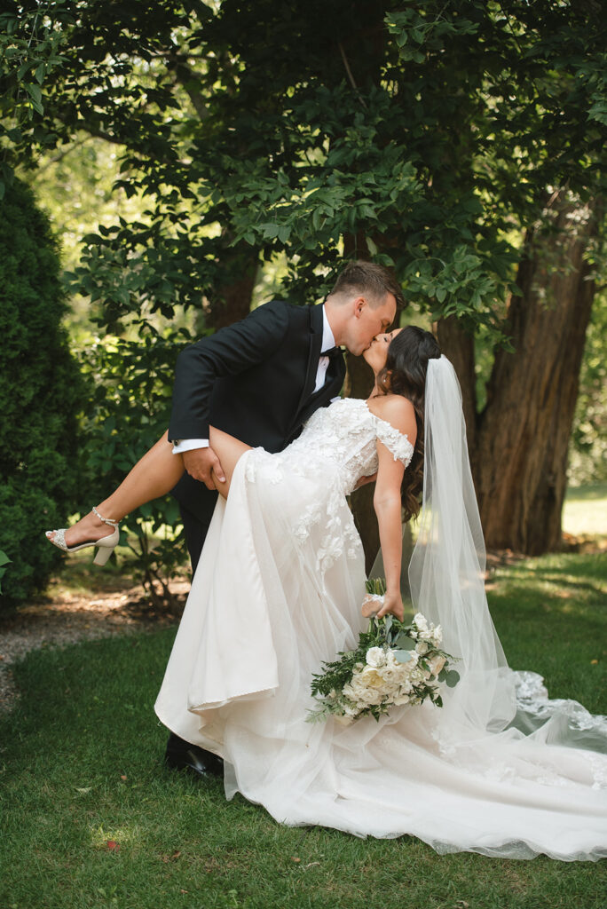 Groom dips bride into romantic kiss at Gervasi Vineyard wedding | J. Lynne Photography