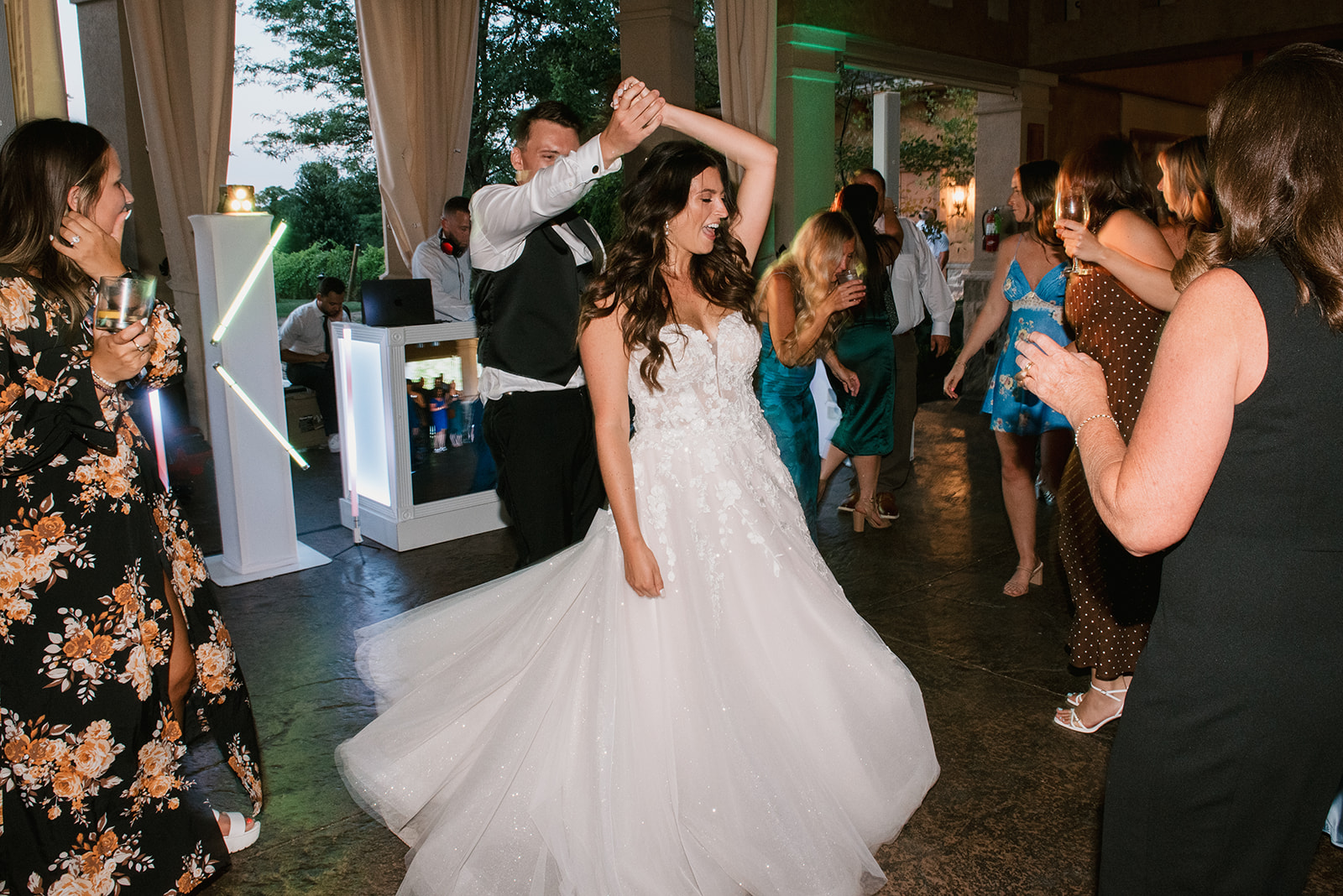 Happy couple celebrates their wedding at their reception | J. Lynne Photography