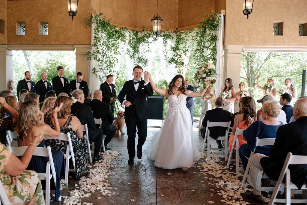 Recently married couple walking down the aisle of their wedding ceremony at Gervasi Vineyard | J. Lynne Photography