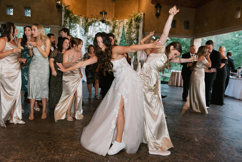 Bride dances with one of her bridesmaids at her wedding in Canton, Ohio | J. Lynne Photography
