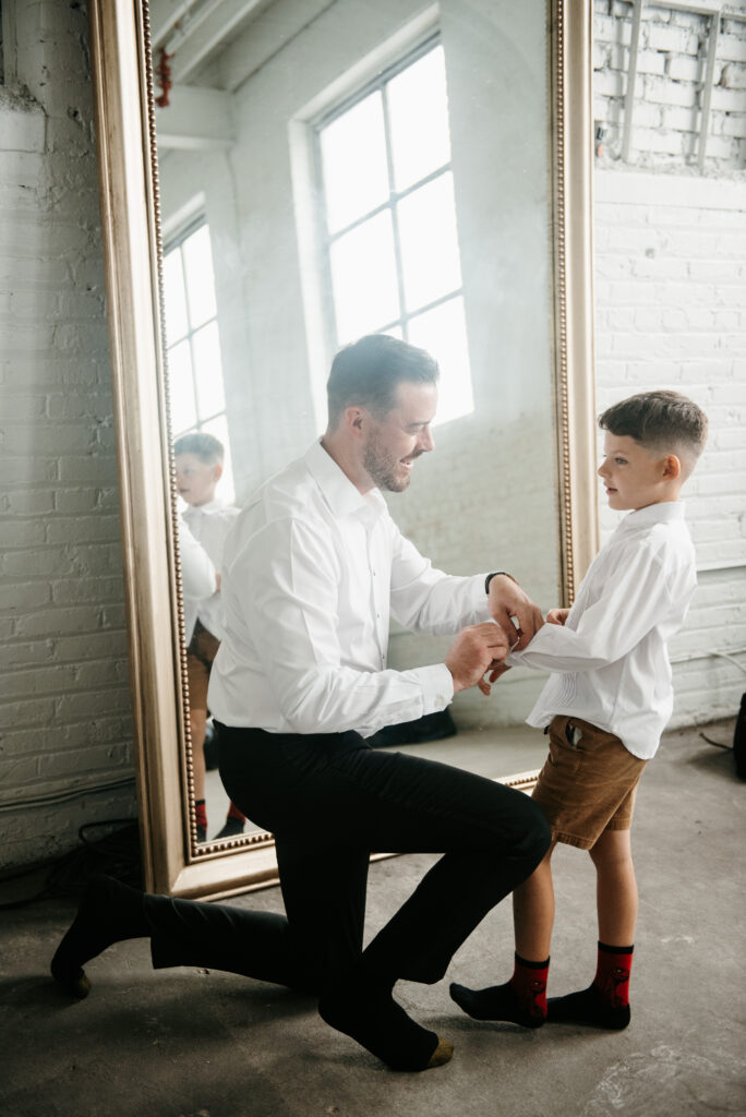 Father preparing for his wedding and helping his young son prepare too | J. Lynne Photography