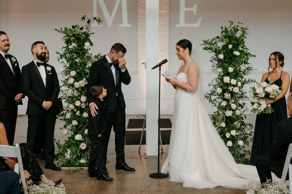 Bride sharing her vows to her husband and their son at The Madison Venue | J. Lynne Photography