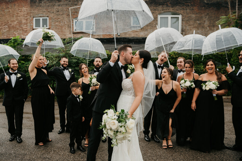 Bride and groom kissing in the snow outside The Madison Wedding Venue in Cleveland, Ohio | J. Lynne Photography