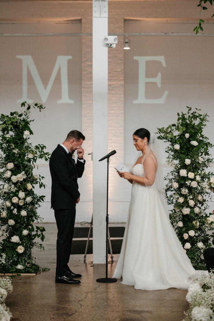 Bride saying her vows at her wedding at The Madison Wedding Venue in Cleveland, Ohio | J. Lynne Photography