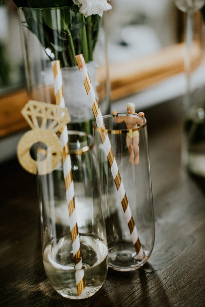 Bride and groom champagne glasses at couple's table at wedding reception | J. Lynne Photography