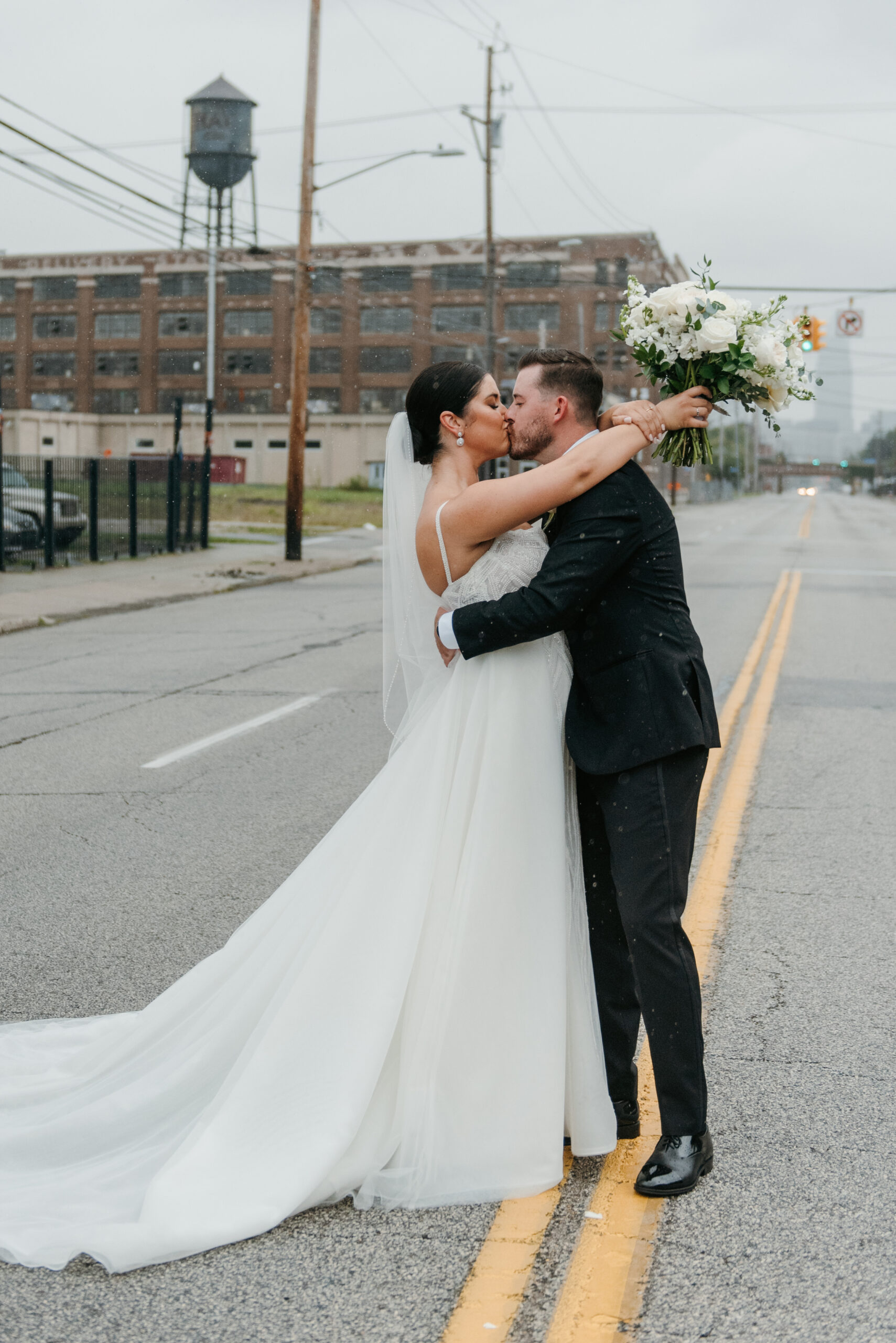 Bride and groom kissing in the snow at wedding in Ohio | J. Lynne Photography