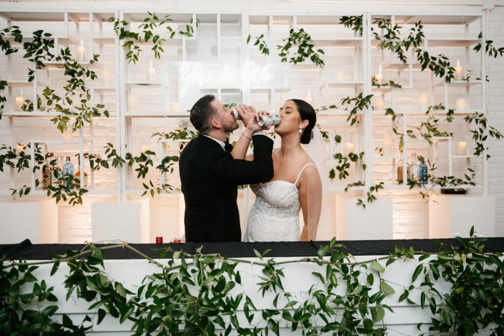 Bride and groom celebrating by sharing a drink in traditional custom | J. Lynne Photography