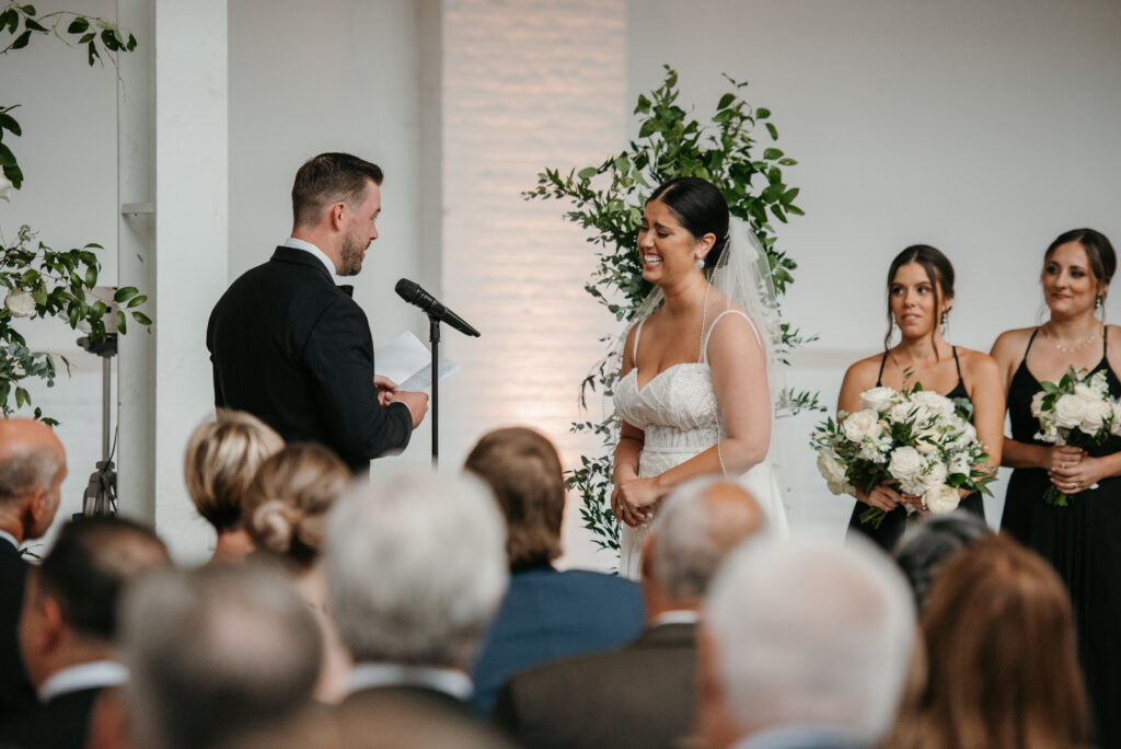 Groom sharing his vows with his bride at wedding | J. Lynne Photography