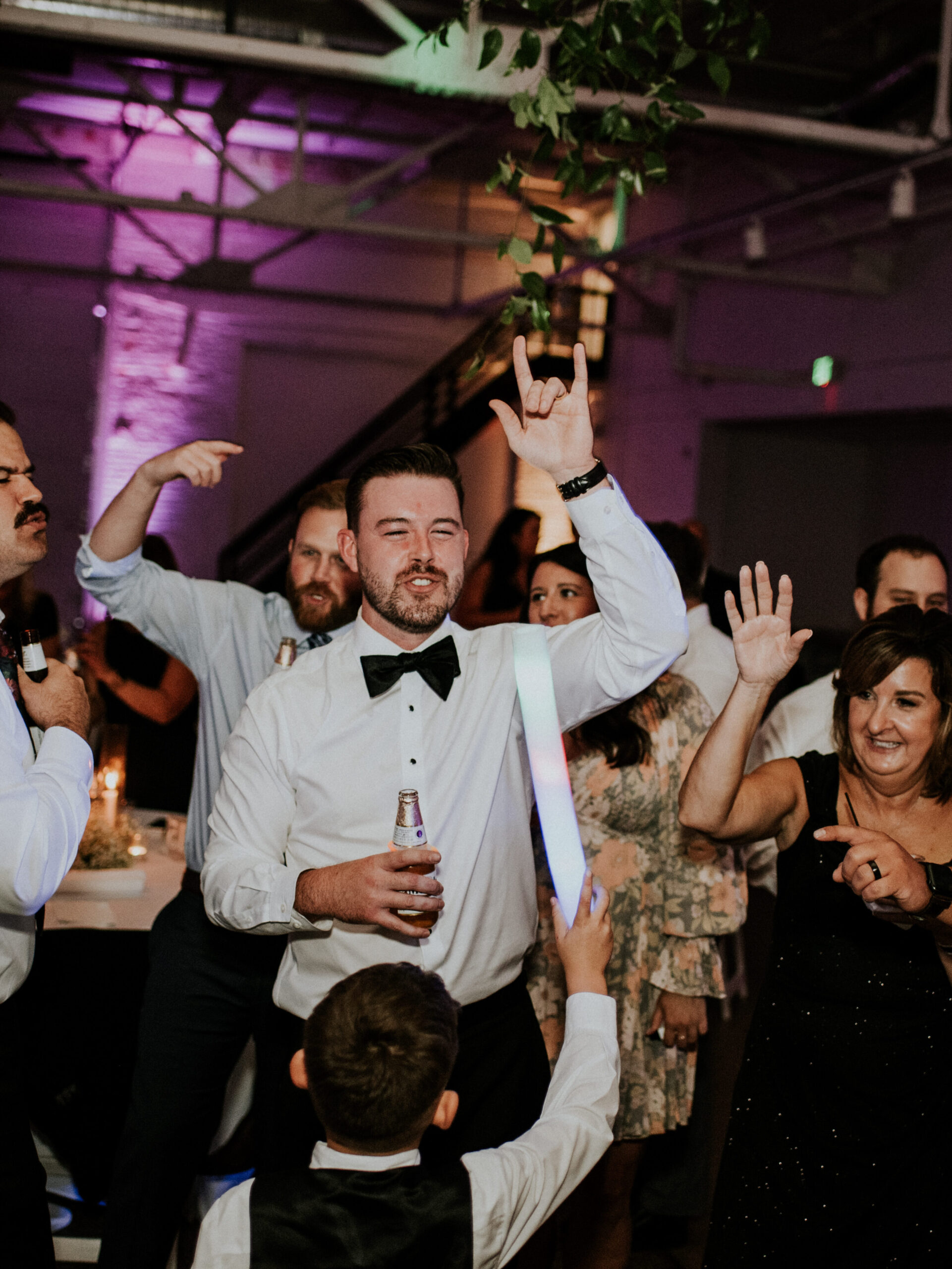Groom celebrating with his son at his wedding | J. Lynne Photography