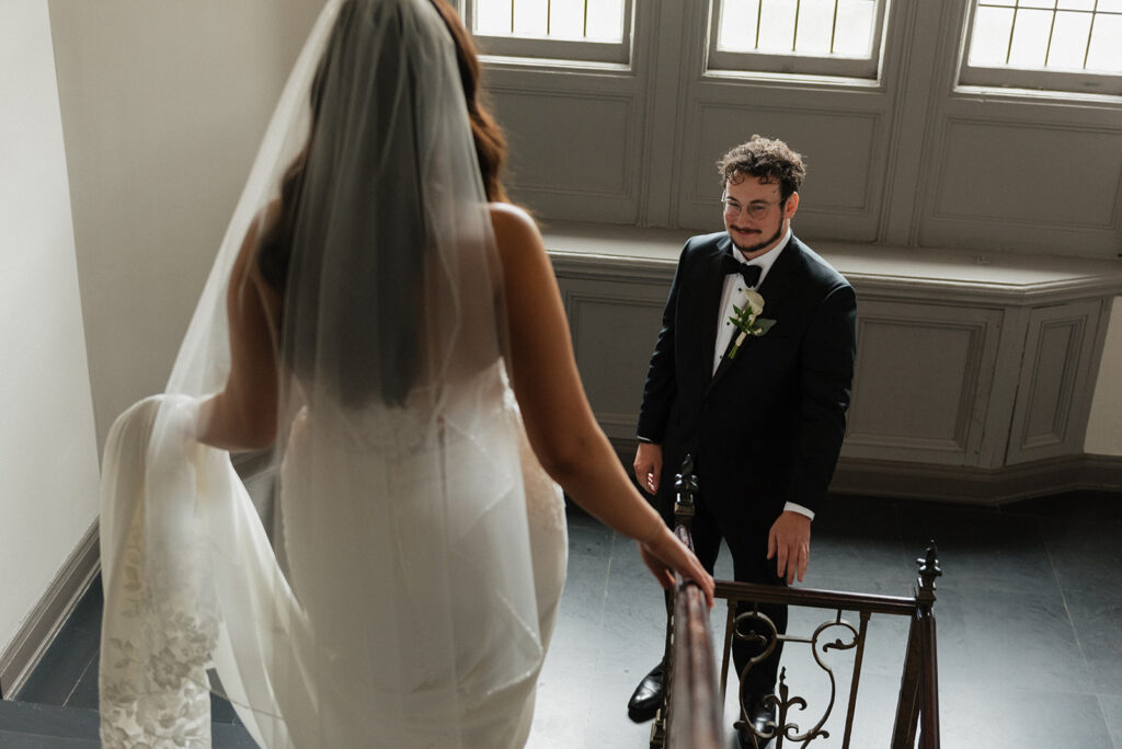 Bride and Groom first look at the wrought iron staircases within the Tudor Arms Hotel | J. Lynne Photography