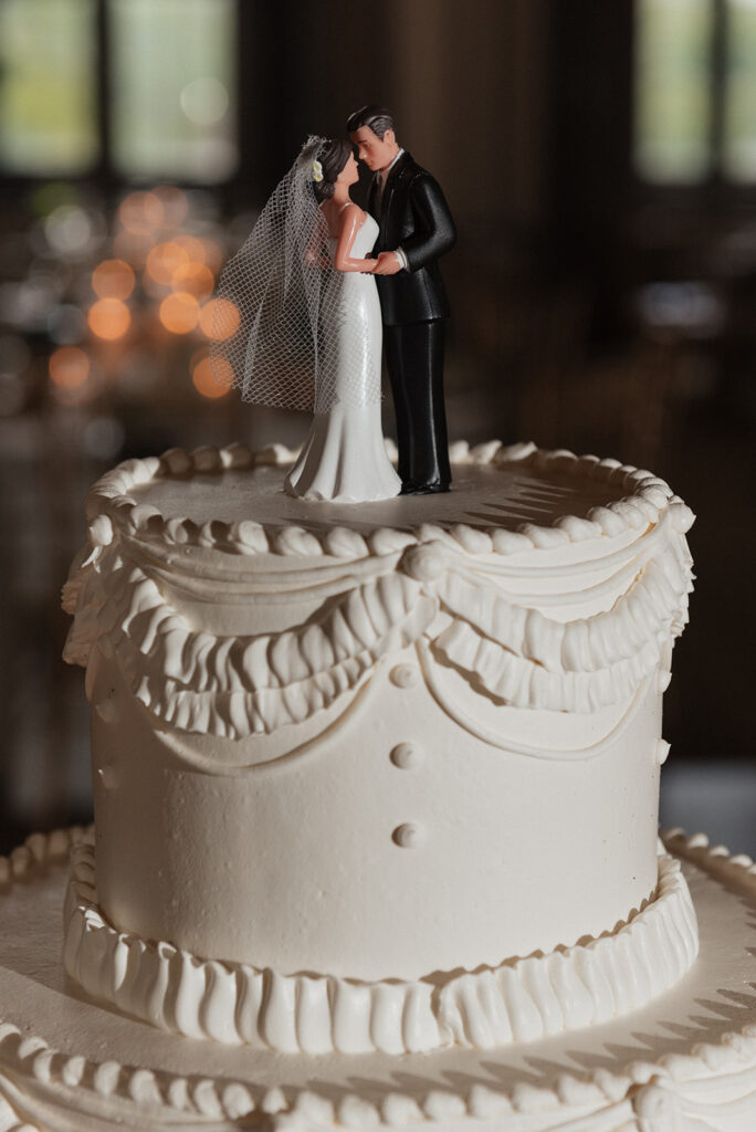 Classic three-tier wedding cake with bride and groom topper | J. Lynne Photography