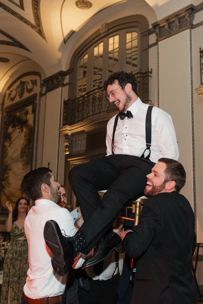 Groom and groomsmen participating in traditional wedding activities | J. Lynne Photography