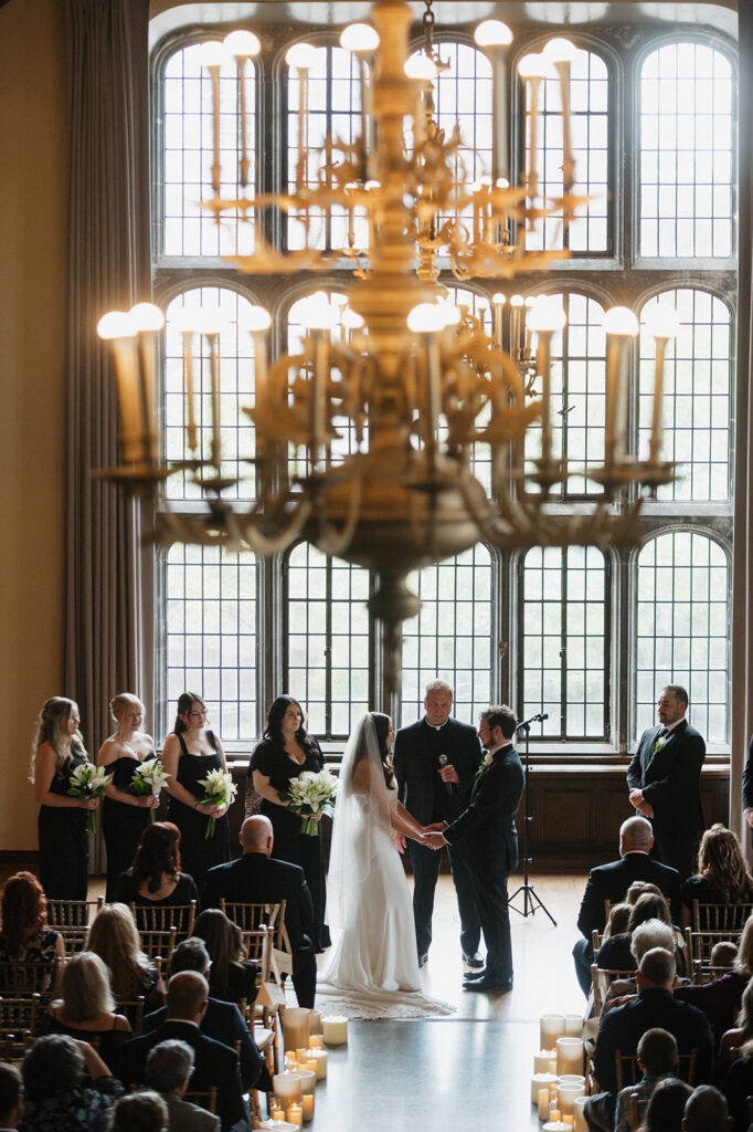 Wedding ceremony in front of floor to ceiling windows in a historic hotel in Cleveland | J. Lynne Photography